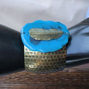 Southwest-style cuff bracelet textured metal band, a large blue resin Piece.